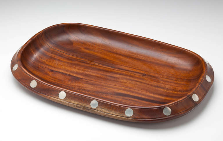 A large and rare bread tray by William Spratling (1900-1967).  The rosewood tray is fluted and inlaid on the rim with 16 sterling silver polka dots.  Signed on the bottom with a conjoined 