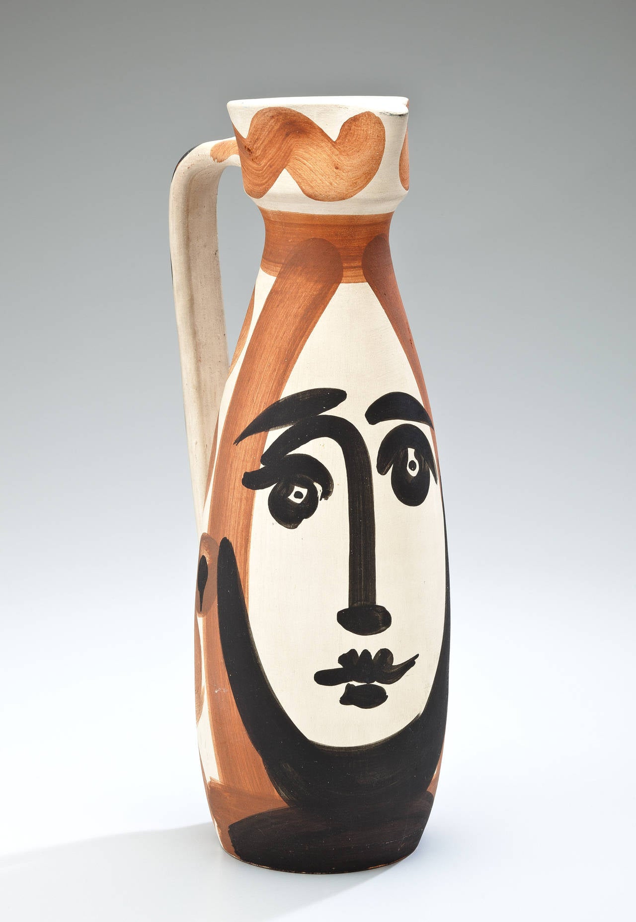 A glazed ceramic pitcher by Pablo Picasso in black, white and brownish red matte glaze, circa 1955. Edition of 500. Signed on the base Edition Picasso Madoura. The pitcher is also signed with the impressed Madoura and Edition Picasso stamps on the