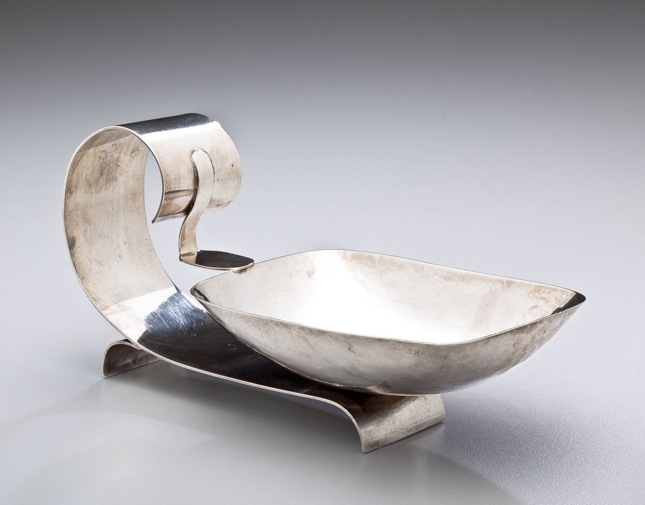 An Art Deco sterling silver serving dish for nuts or candy by California sculptor and silversmith Philip Paval. Paval's handcrafted and elegant designs were popular with the Hollywood greats of the period. Today his work is highly desirable but