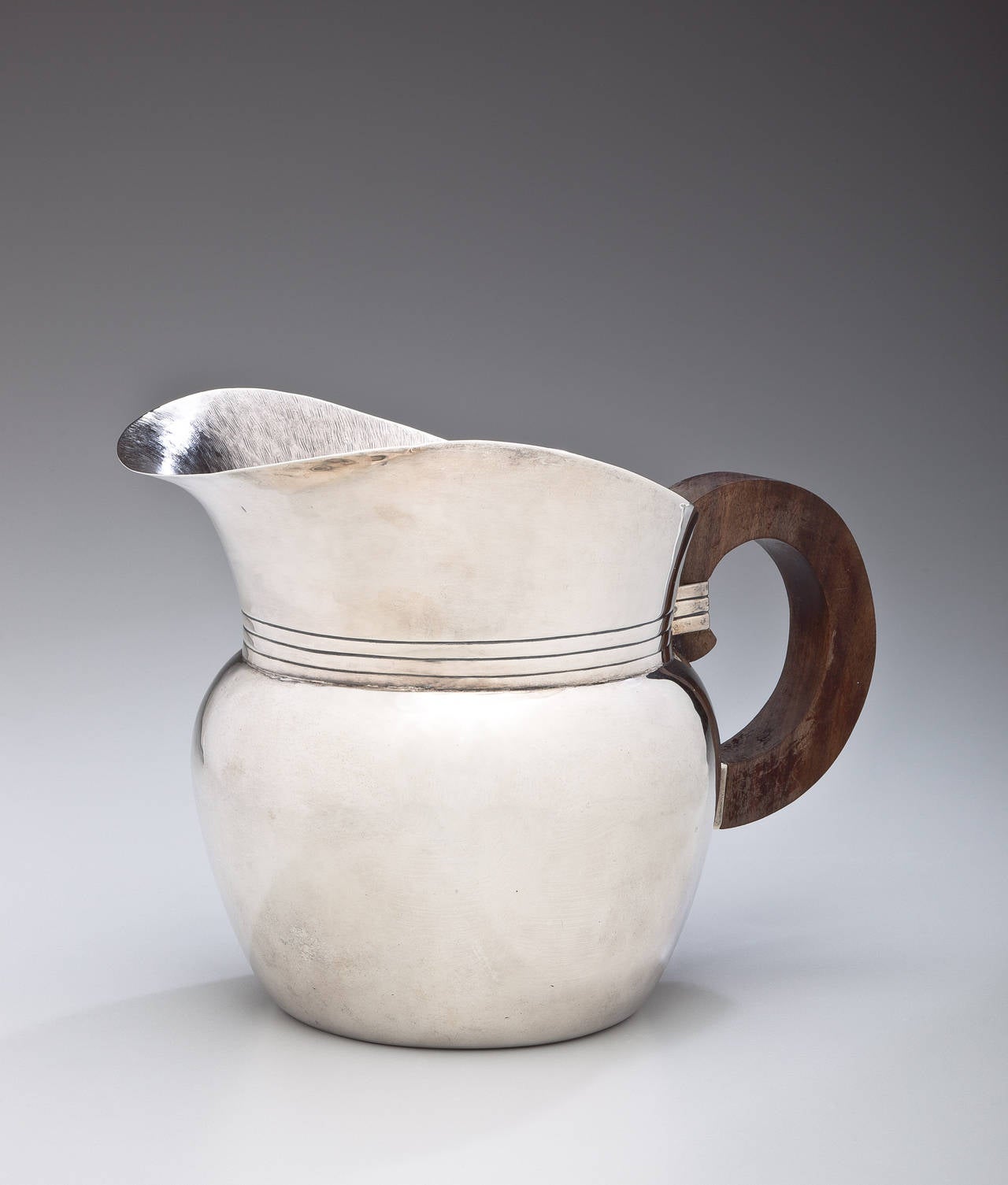 A pitcher in sterling silver and rosewood by William Spratling (1900-1967). Called the 
