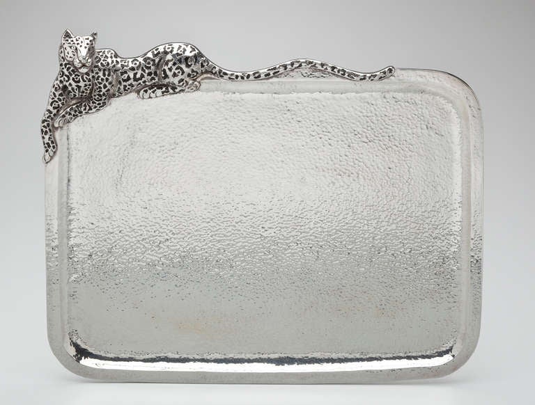 A dramatic sterling silver tray with a recumbent  jaguar draped over the top by Mexican artist, Emilia Castillo.  The jaguar's spots are highlighted with niello, a technique of metal ornamentation  that blackens the silver.  Hand hammering is