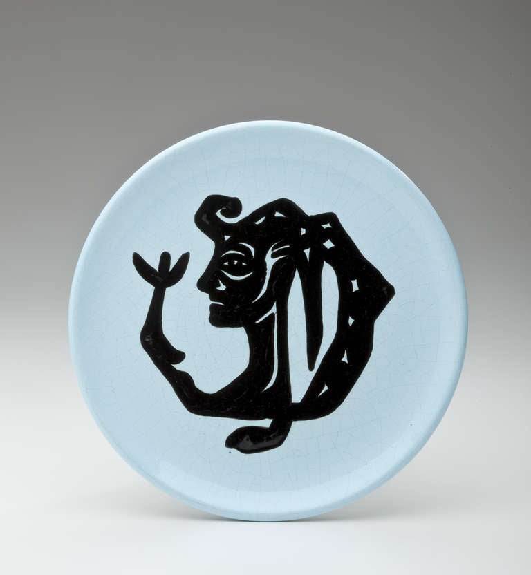 A set of three pottery plates by Jean Lurcat depicting three surreal figures in black and blue glazed earthenware.  Lurcat, (1892-1966) was a post cubist expressionist painter, stage designer, ceramicist and most importantly, a designer of