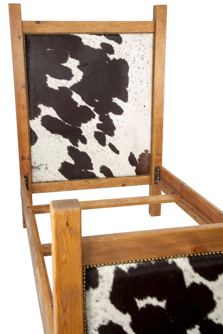 Authentic black and white cowhide twin bed frame with nailhead trim. Perfect for a young cowboy or even one that's grown up!