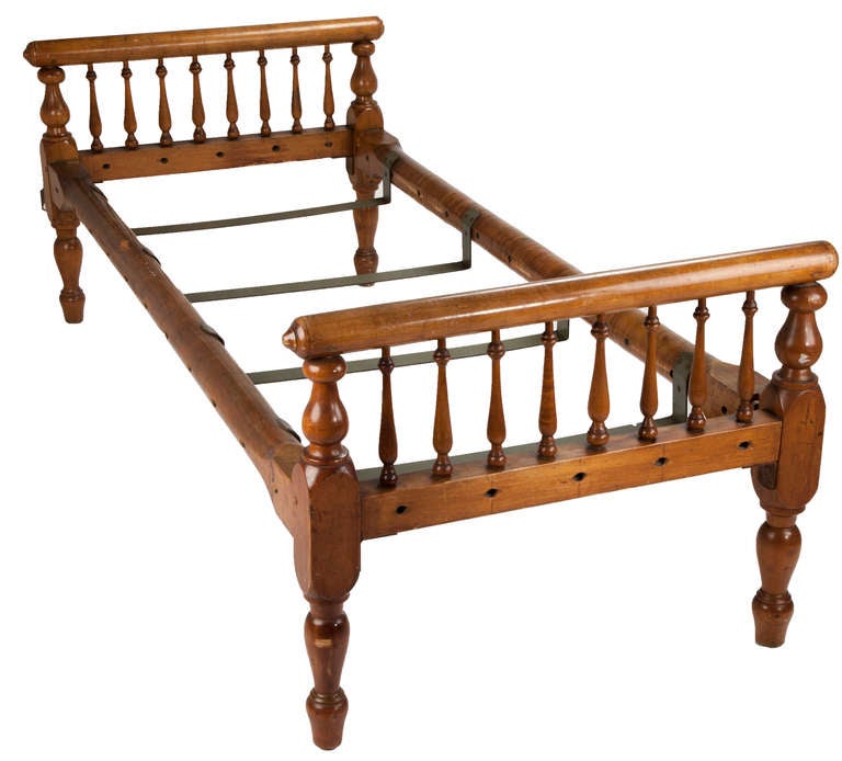 American maple daybed with bobbin turned legs and slender spindles lining the head and foot boards or arms with metal slats to support mattress. No longer having rope suspension for holding early mattress.