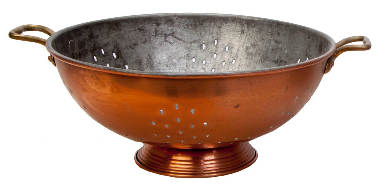 Marked Waldow, Brooklyn, NY. Large is 11 inches in diameter raised on a stepped base with copper rivets. Small is 9 inches in diameter also with stepped base. Both are riveted brass handles and tin lining.