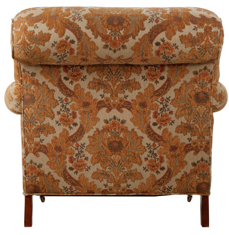 Pair of scroll-back Odom style Club chairs, upholstered in a rich gold chenille tapestry with self welt, turned front legs with brass casters.