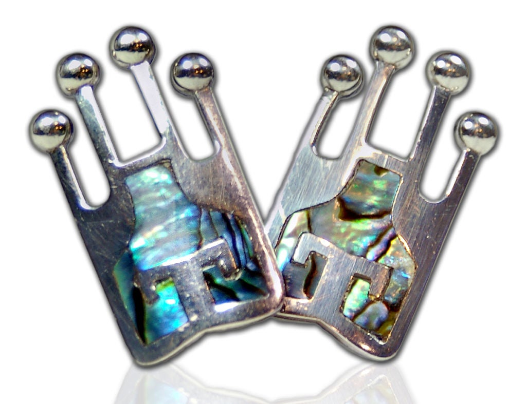 Vivid iridescent abalone set in sterling silver. Abstract Aztec emperor design by well known avant-garde artist Miguel Garcia Martinez. Martinez was an appretince to William Spratling, the father of the modern silver movement in Taxco, Mexico.