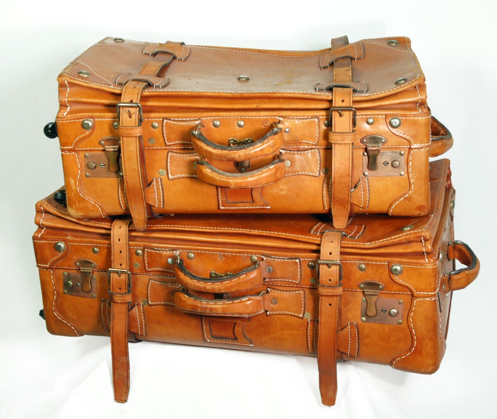 Vintage luggage was built to last. Such exemplary models are a case in point. These solid leather portmanteaus have reinforced corners, copper rivets, exterior straps and hand stitched handles which make them as sturdy as they are strapping.