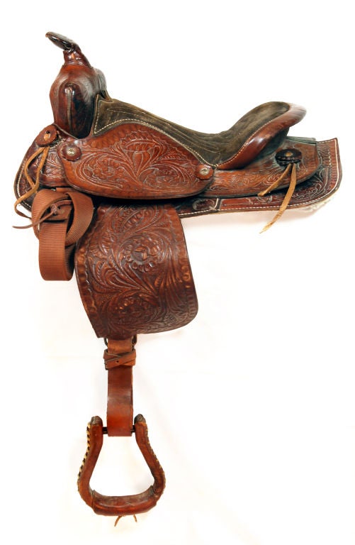 These exquisite equestrian artifacts have both aesthetic and utilitarian value. Each saddle is intricately hand tooled with its own motif, one complementing the other; sunflowers adorn one, acorns another and desert roses the third. They range in