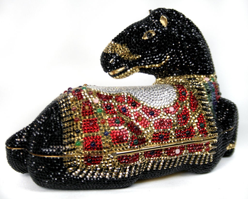 This rhinestone encrusted horse handbag is absolutely exquisite. The Minaudière is lined with gold and complete with small gold mirror and comb. <br />
Judith Leiber was born and raised in Budapest, Hungary, where she studied the craft of handbag
