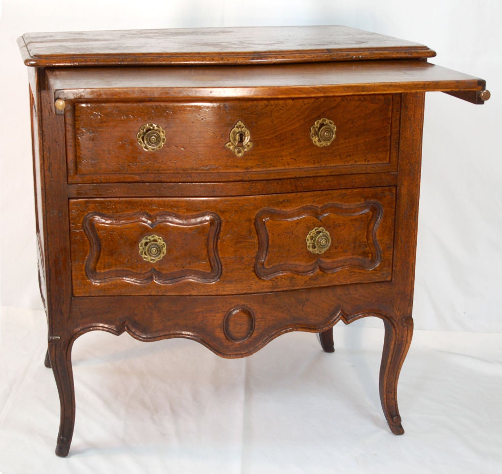 Beautiful French Walnut nightstand by Don Ruseau of New York. This mid-century reproduction of a Louis IV French Provincial nightstand was of the highest quality when it was made. Beautiful French walnut with brass fixtures. Graceful bombe front