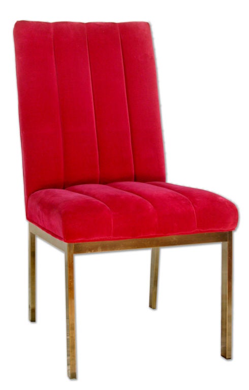 This pair of midcentury Parsons chairs sit upon chrome bases. They are covered in channeled vivid raspberry velvet upholstery with piping. The artfully executed upholstery gives these chairs both the sharp clean lines of midcentury design and the