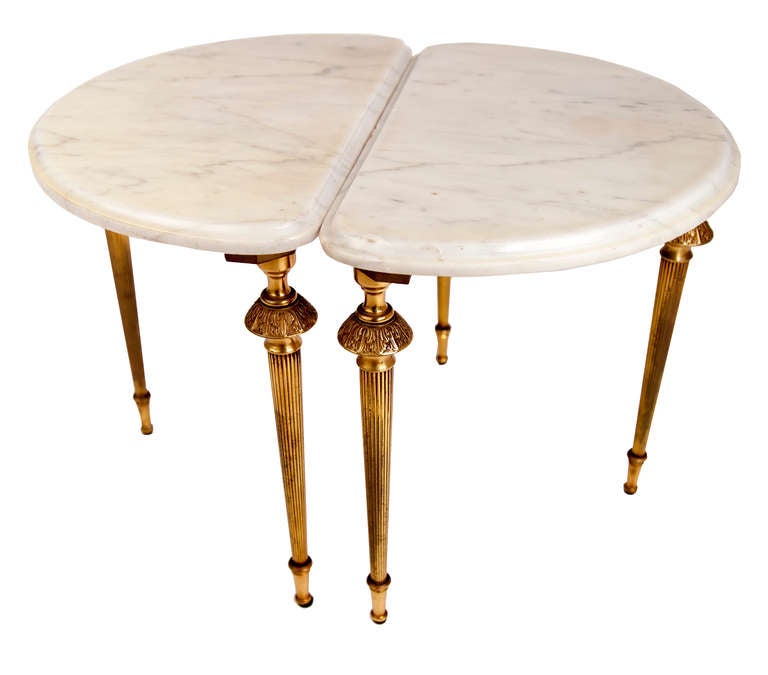 These demilune marble occasional tables have solid brass legs which screw into a brass sub frame under the ogee edged statuary marble tops.