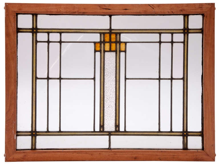 Twin deco stained glass with gold and clear toned glass panels among parallel leaded designs.