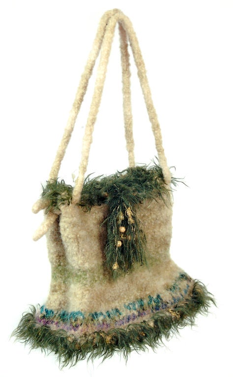 Whimsical mohair purse handmade with colors of cream, turquoise, purple and olive is loosely tied with gold thread and beads. In the style of 1970s fiber work.