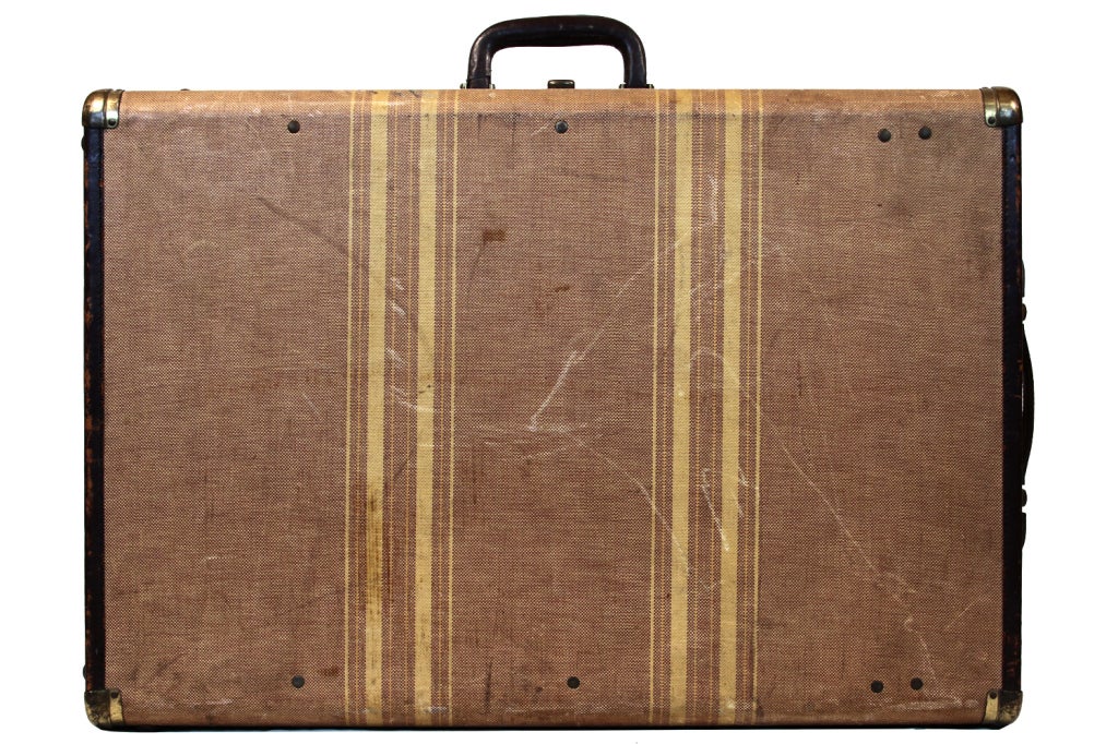 The cardboard suit case has become an icon of 20th century history, bespeaking a myriad tales of emigration, displacement and homecomings. This suitcase, manufactured by Aero Pak of Petersburg Virgina, features a two yellow stripes on the exterior