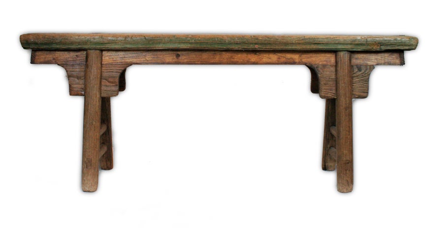This simple, rustic Chinese bench from Shanxi Province, China features rounded legs grafted into an 