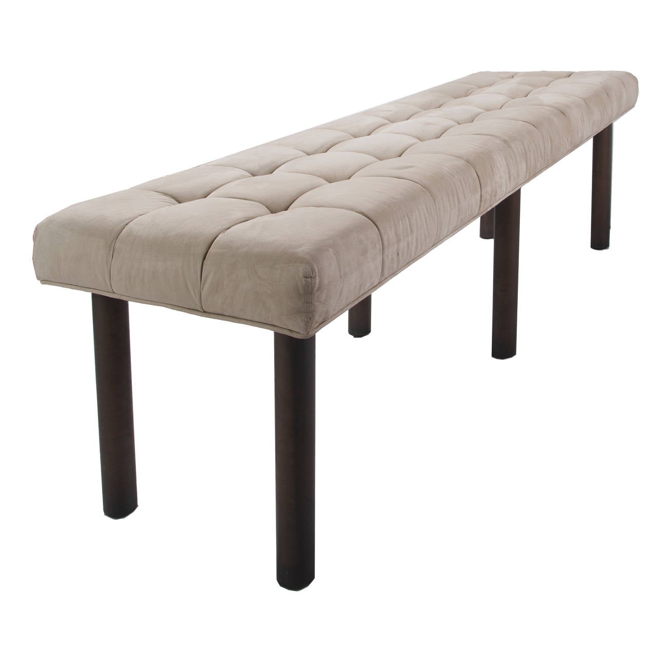 Pale gray tufted plush fabric on long rectangular stool base with six tubular industrial style metal legs. Nicely completed with metal designer feet bottoms.