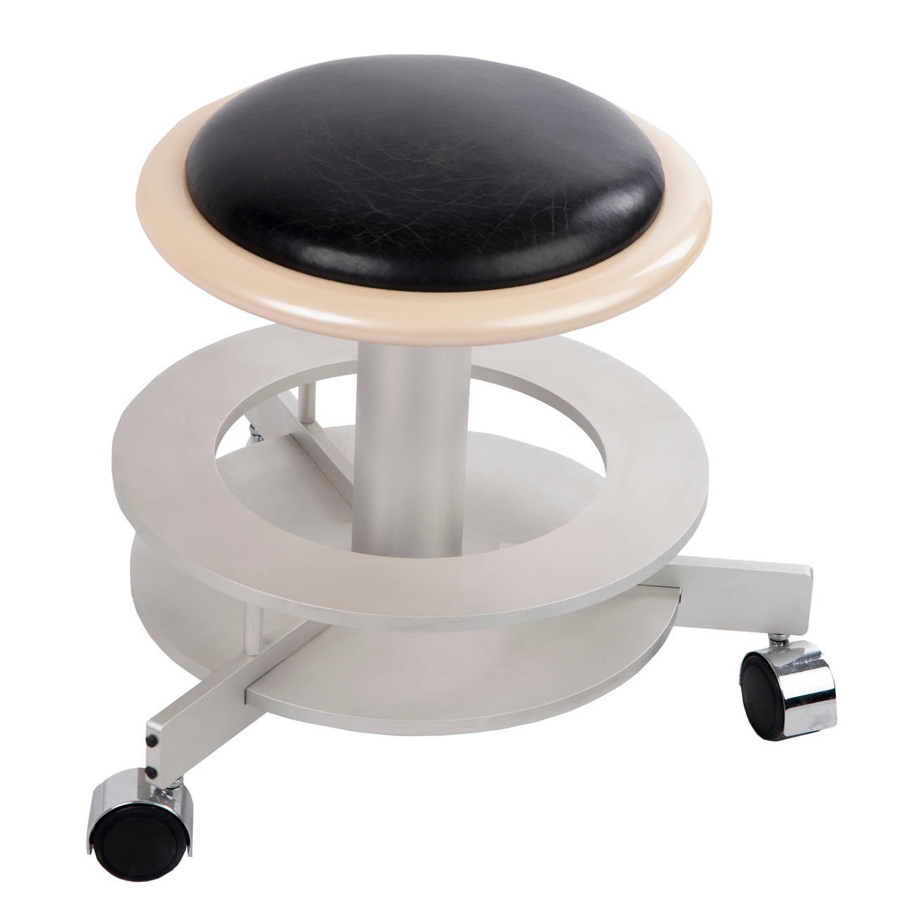 Black leather with wood trim on metal base with rolling casters. Handy for rolling around with low detailed work.