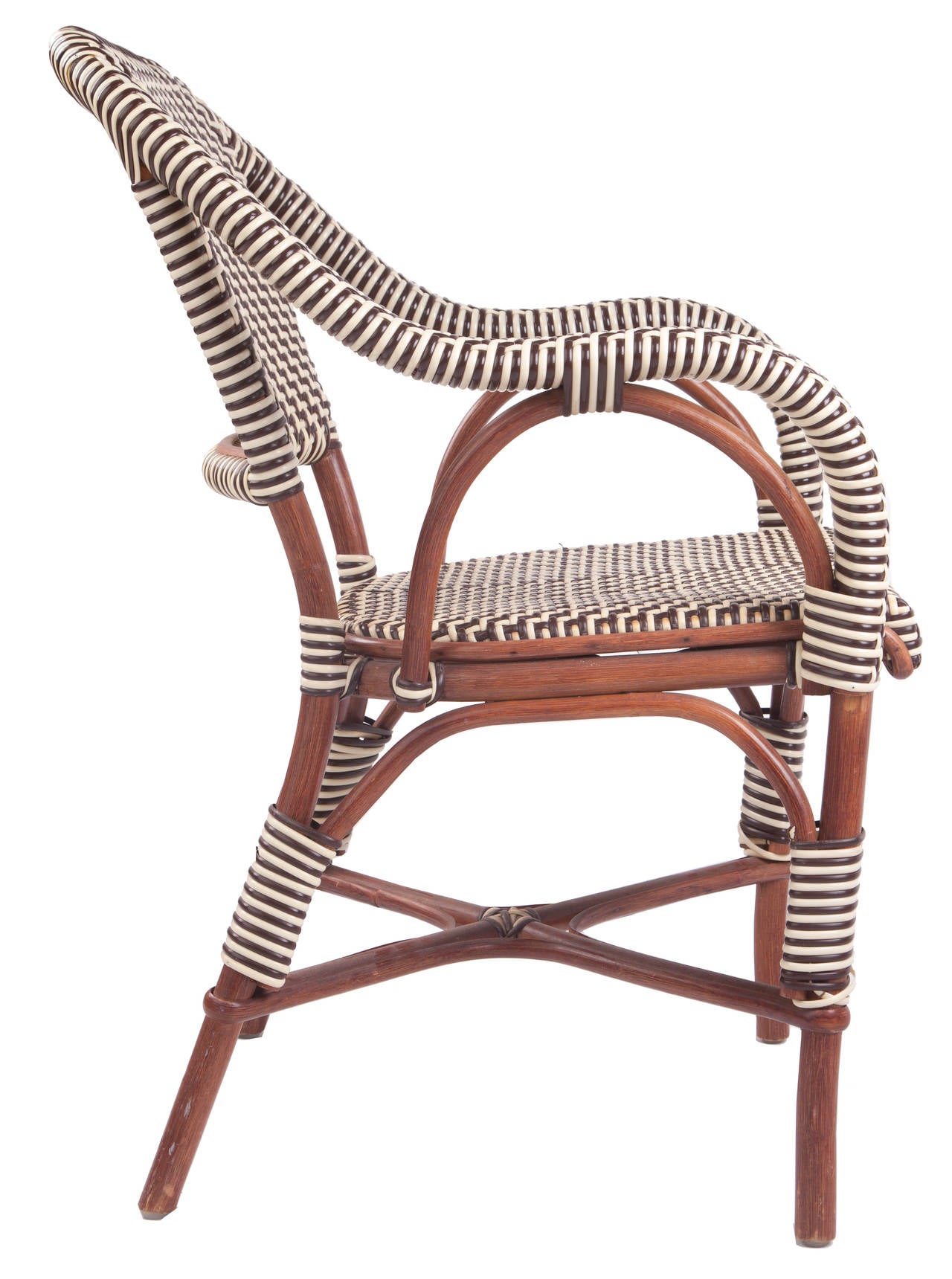 This cafe chair was meticulously handcrafted in France of the finest natural materials. First the rattan frame of the cafe chair is steamed and hand formed after which each cafe chair frame is then handwoven with Rilsan, a trademarked material