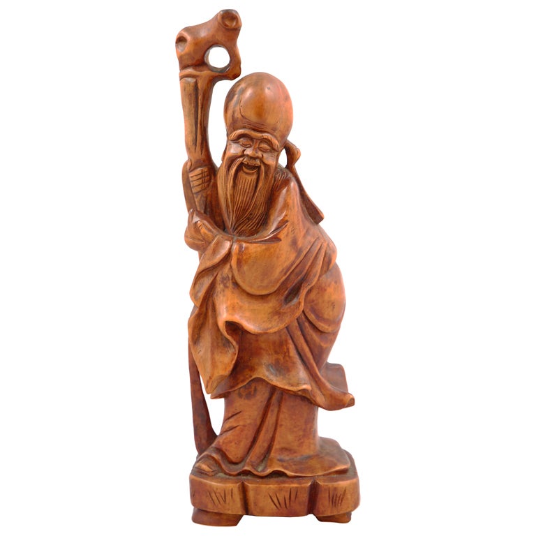 Figure chinoise en bois sculpté d'immortel barbu tenant un bâton en vente