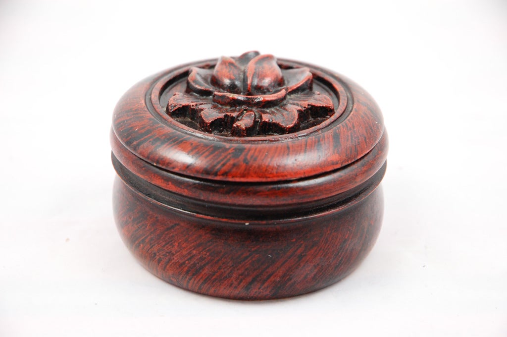 This set of six rosewood coasters sit in a cinnabar finished box with carved stylized rose on top. Chinese export style.