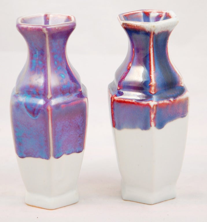 This pair hexagonal ceramic vases feature a wonderful multi toned flambe glaze. This traditional Chinese form has been given a midcentury treatment similar to examples from Haeger.