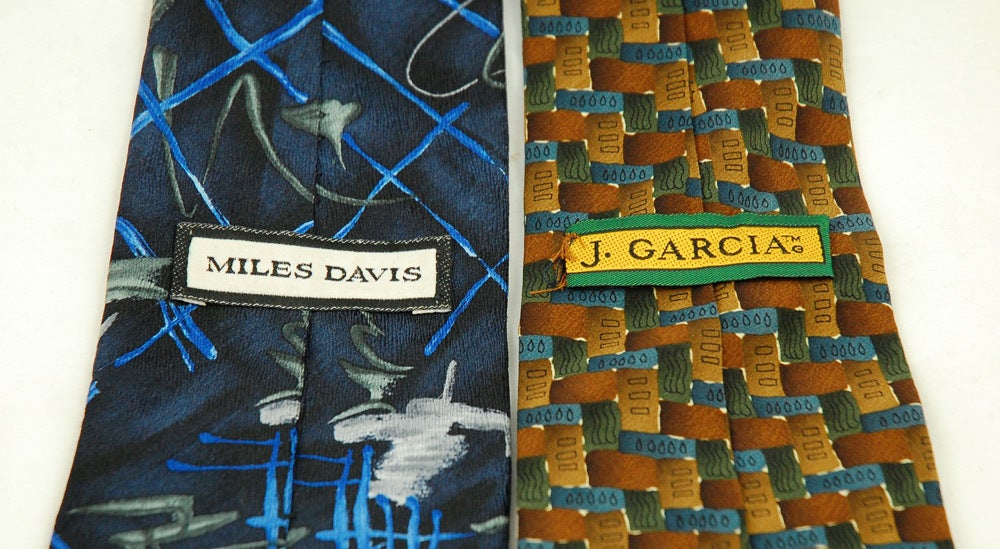 This beautiful pair of abstract ties celebrate two great American musicians. The Jerry Garcia Necktie is made of silk and features an abstract design in blue and green, orange and yellow. The design was based on Jerry Garcia's art work. Jerry Garcia
