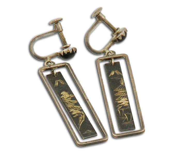 This pair of Japanese earrings feature lovely etched pagodas with Mount Fuji suspended in a rectangular metal frame are suspended from Jet studs.