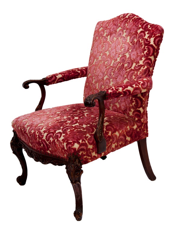 Beautiful, rich dark mahogany victorian style padded armchair with Cranberry floral brocade. Delicate ancanthus leaf carving with generous proportions and interesting scale.