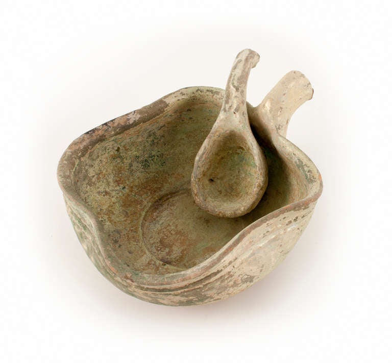 Chinese Han or in the style of Han (B.C. 206-A.D. 220)  Clay bowl with ladle. Red clay body with an iridescent glaze patination. Handled square bowl with pinched-in rim.