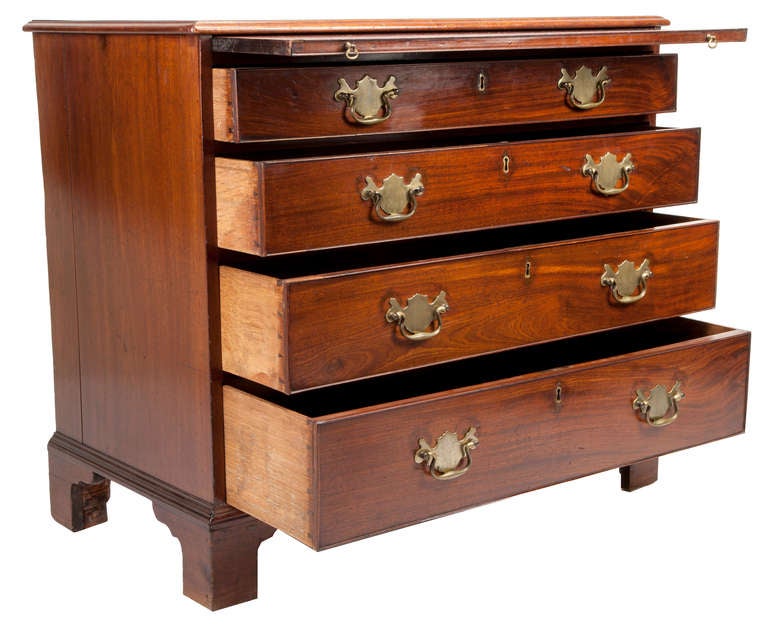 British, 18th century with four dove-tailed drawers, with pull-out at top, oak secondary woods, original bracket feet. Nice Chippendale brasses with brass key escutcheons.