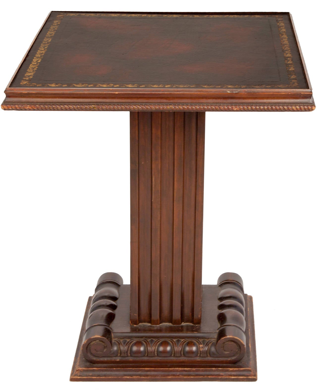 This pair of Grosfield House tables are raised on square bases with carved volutes and egg and dart molding. Square fluted shaft supports a square top with carved rope molding around the outer edge. Nice mottled chestnut colored inset leather tops