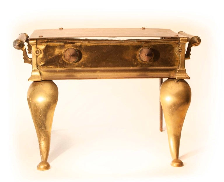 Beautiful antique brass bench andiron used for warming tea kettles and irons by the fireplace.