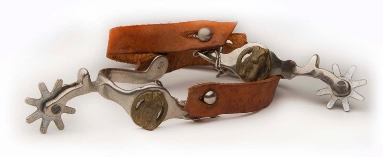 Wonderful rustic leather spurs with silver steel hardware and brass horse head mounts.