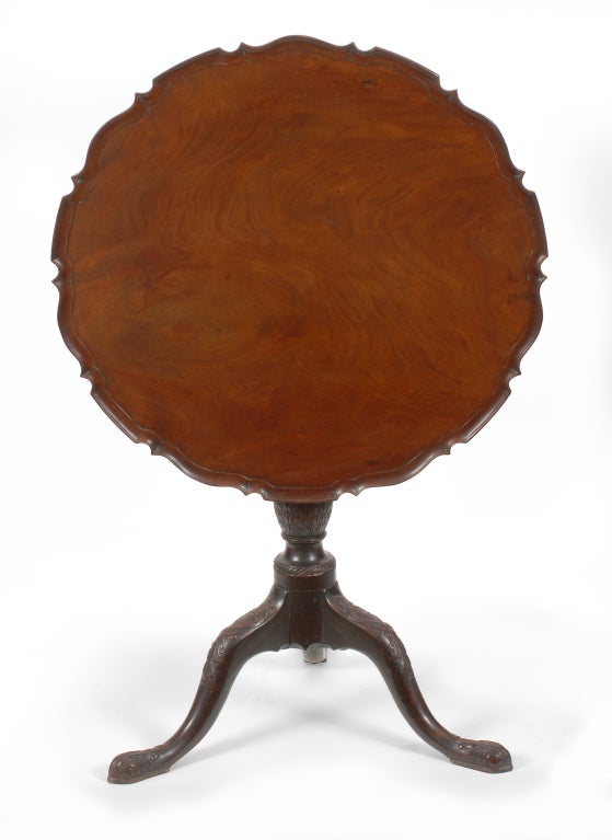 A very fine Chippendale mahogany pie crust tilt top candle stand in old surface, probably English or Irish, circa 1760-70. This stand is constructed of high quality dense mahogany and has rich detailed carvings on the post and tripod legs.  The 