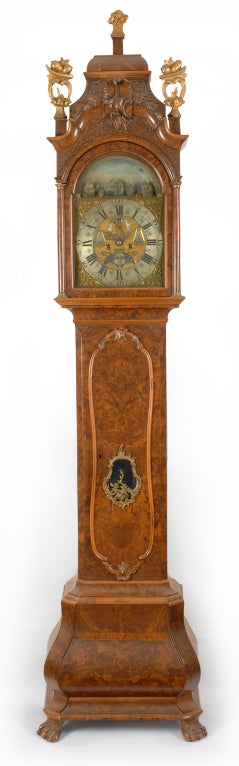An impressive burl walnut Dutch bombé base tall case clock with harbor automation, alarm and complications by J. M. Heyer, Amsterdam Holland, circa 1785.  This dramatic full size case is highly ornamented including choice burl veneers and a full