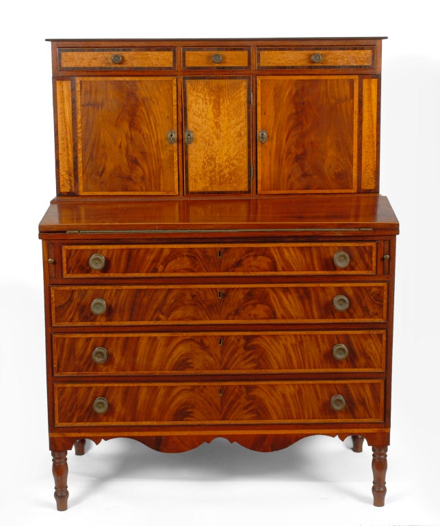 A handsome Federal mahogany secretary desk, probably Southeastern Massachusetts, circa 1815.

This attractive antique Sheraton secretary desk was produced in the Federal manner with abundant contrasting inlays and beautiful figured mahogany. Blind