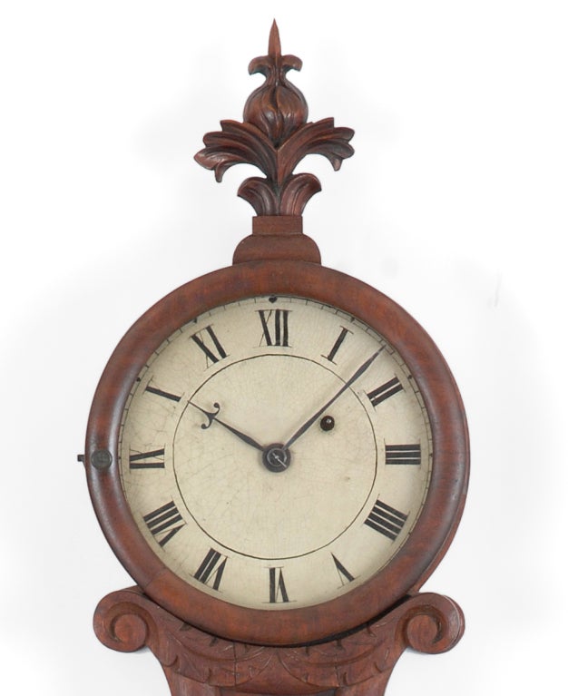 This classical interpretation of the banjo clock is fashioned in the form of a lyre, an emblem associated with the major deity Apollo, chief muse and god of sun and light. This theme was a popular motif in neo-classical and empire timepieces. The