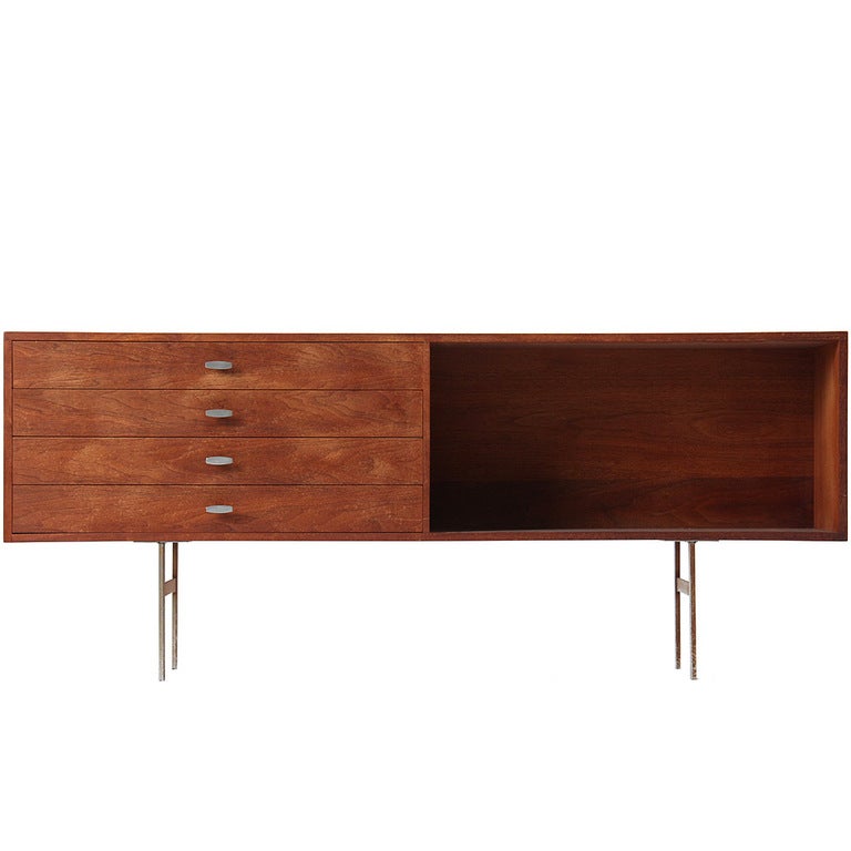 A low credenza with four drawers and an open case on a simple stainless steel frame. Unit height without legs is 15