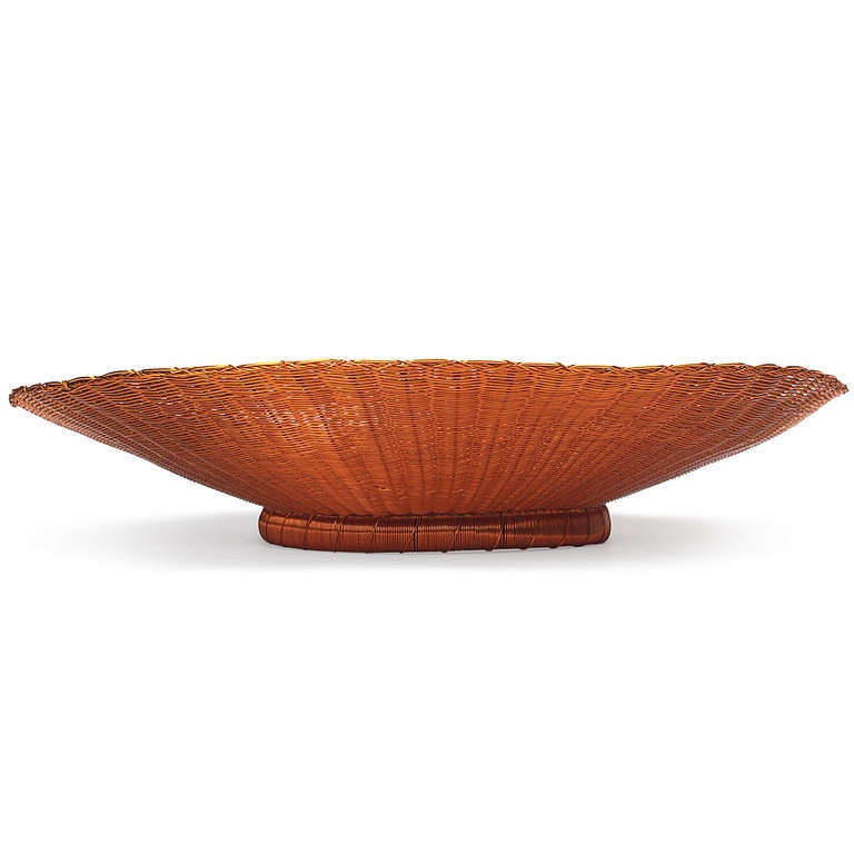 An unusual and finely rendered footed and subtly undulating bowl crafted entirely of woven copper.