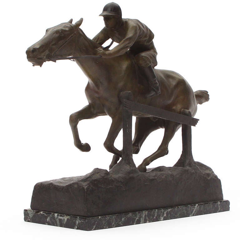 A finely modeled and dynamic signed sculpture depicting a jockey racing a thoroughbred horse, mounted on a figured marble base.