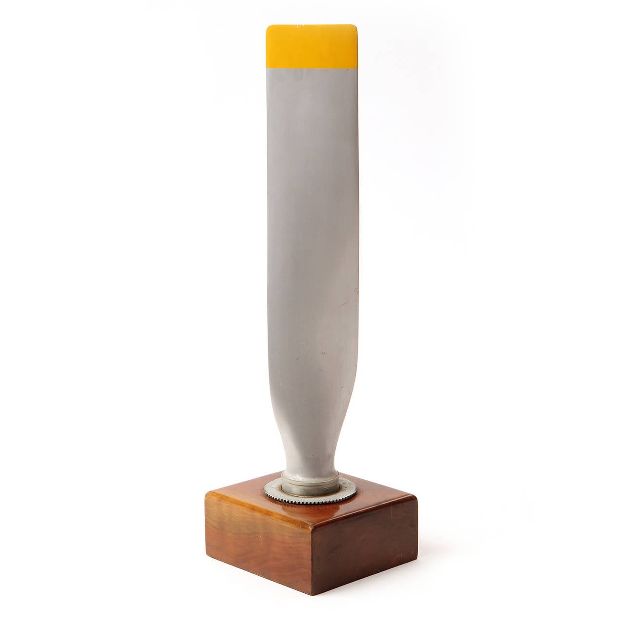 A striking and beautifully fabricated aluminum propeller blade with a lacquered yellow accent, finely mounted on a figured walnut base.