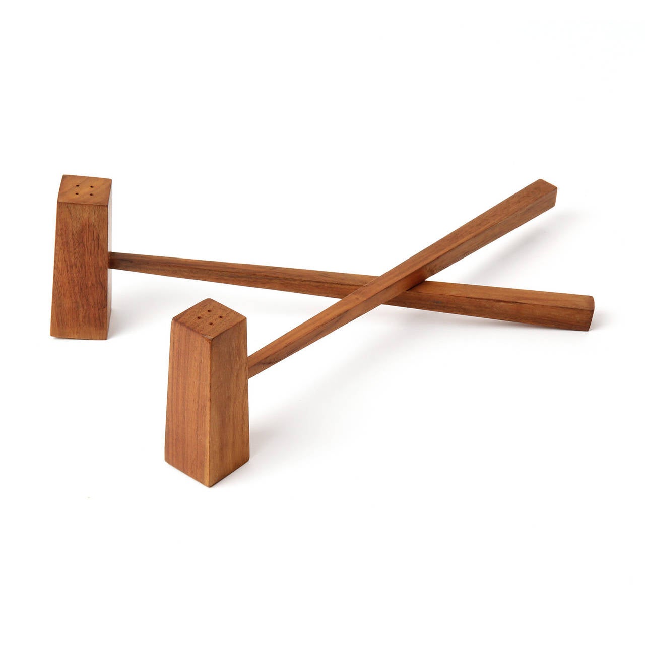 An unusual and finely crafted pair of salt and pepper shakers of tapering rectangular form attached to solid teak tapered squared handles.