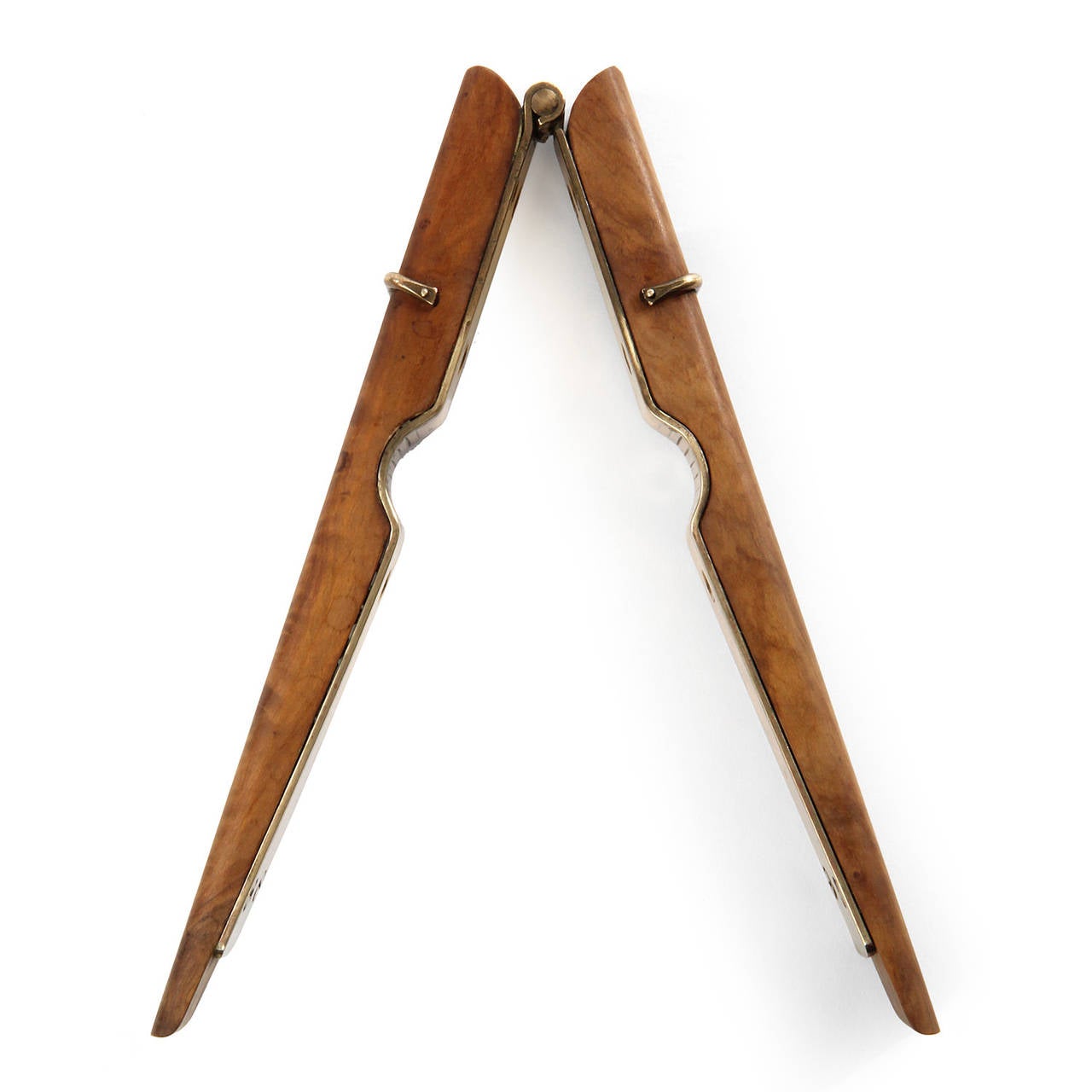 An expressive and finely rendered nut cracker in bronze and walnut having the form of an oversized clothes pin.