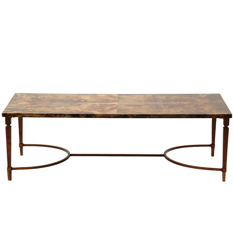 A parchment covered patinated low table. Marked made Italy