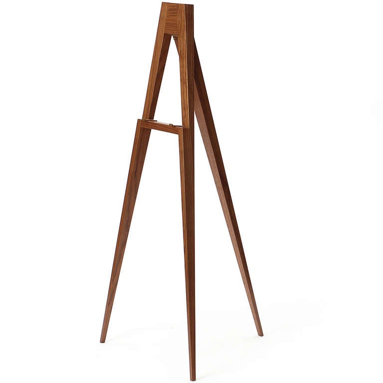 A superb and highly functional modernist solid walnut easel with elegantly tapered legs and brass hardware, designed by Edward Wormley.