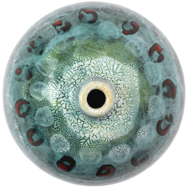 An expressive hand-thrown ceramic sculpture having a variegated green-to-light grey complex glaze punctuated by reddish circular additions.