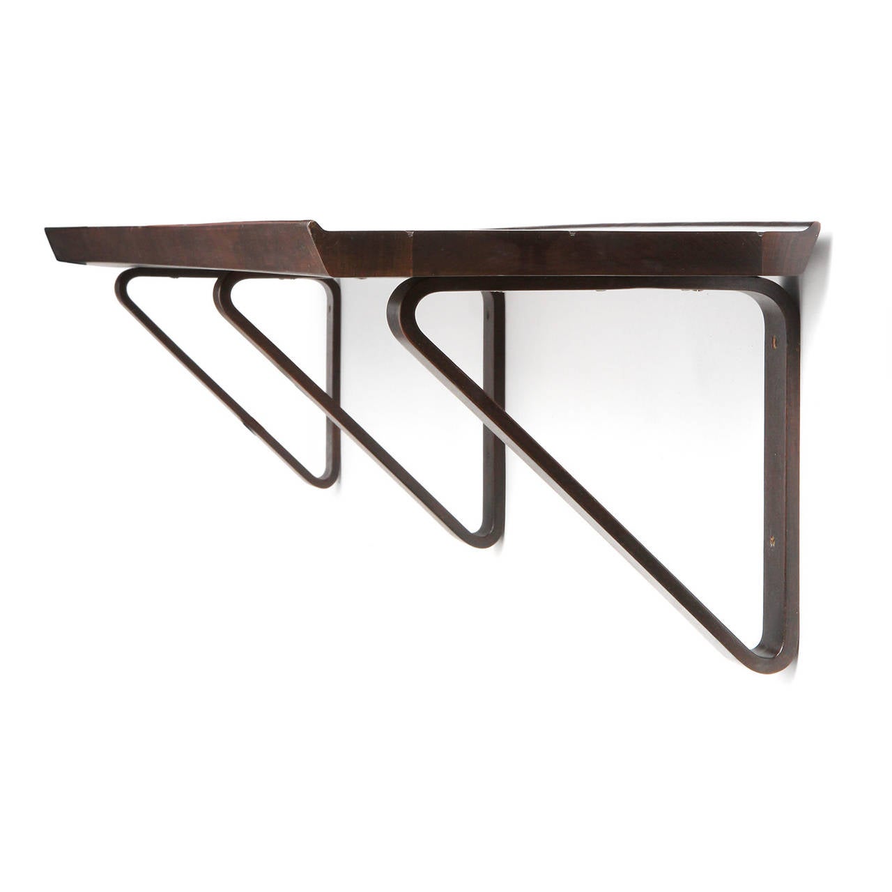 A finely crafted,  substantial and elegant wall shelf in rich walnut having three laminated continuous loop wood brackets supporting a slatted shelf with a beveled edge.