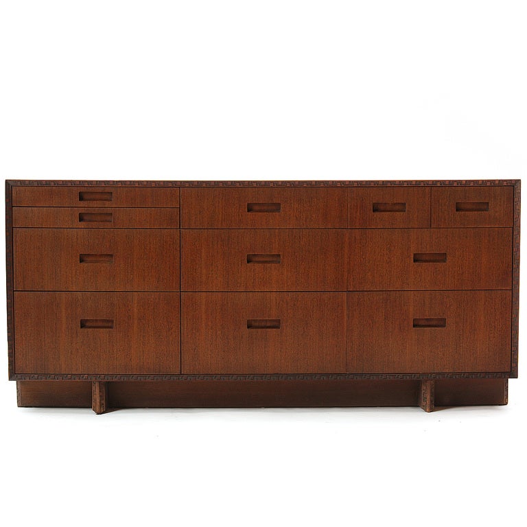 An eleven (11) drawer mahogany dresser with carved 'Taliesin' frame.